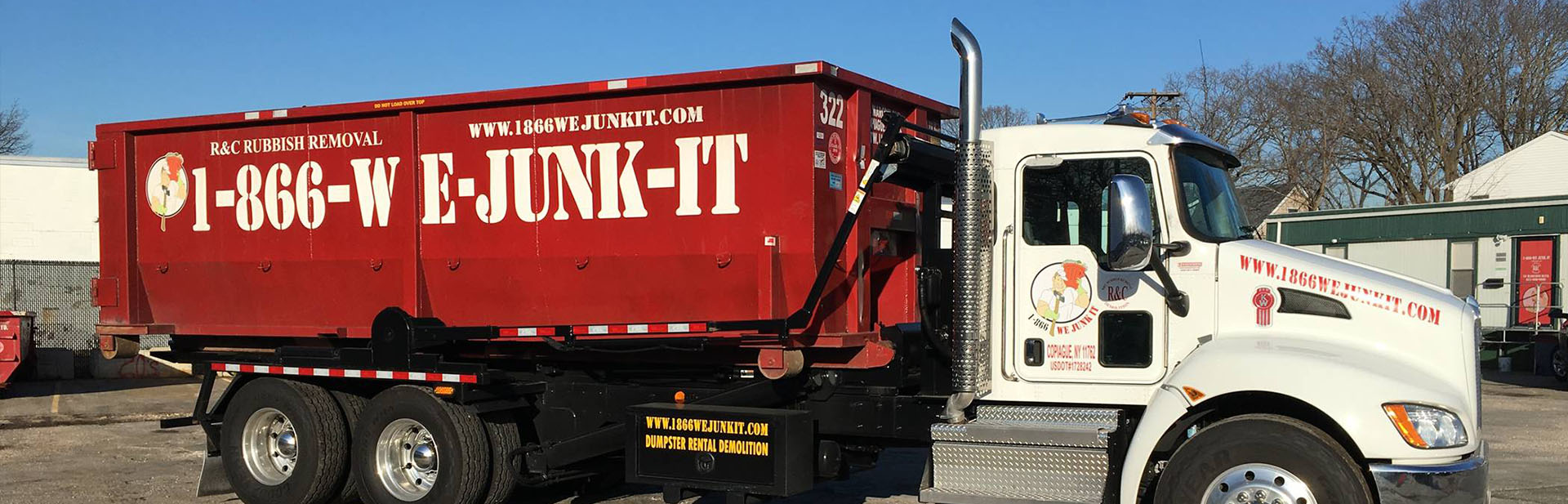 1-866-WE-JUNK-IT roll off truck with a red dumpster ready for delivery in Hempstead, NY